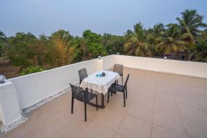 a table and chairs on top of a balcony at SAI 4BHK VILLA ALIBAUG in Alibaug