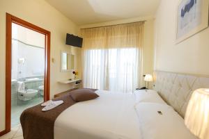Postel nebo postele na pokoji v ubytování Hotel Nuova Sabrina