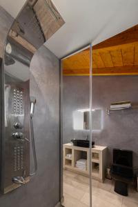 a shower with a glass door in a bathroom at Andros 4 All Seasons Villas & Suites in Andros