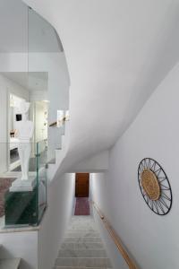 a white staircase with a glass case on the wall at Andros 4 All Seasons Villas & Suites in Andros