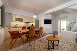 a kitchen and dining room with a table and chairs at Andros 4 All Seasons Villas & Suites in Andros