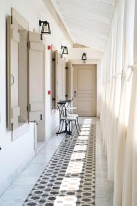 a hallway with black and white flooring and a table at Viento Alacati Hotel in Alaçatı