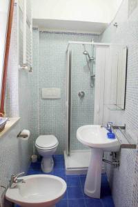 a bathroom with a toilet and a sink and a shower at Dei Meravigli in Bari