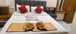 een hotelkamer met 2 bedden en handdoeken erop bij Atithi Homestay in Tirupati