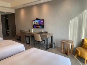 TV a/nebo společenská místnost v ubytování Jin Shi Hu Hotel