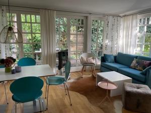 sala de estar con sofá azul y sillas en Meerlust Spiekeroog en Spiekeroog