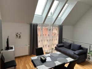 a living room with a couch and a table at Paky Appartements 00323 in Bruck an der Leitha