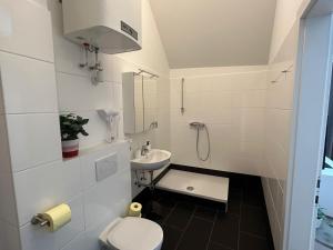 a small bathroom with a toilet and a sink at Paky Appartements 00323 in Bruck an der Leitha