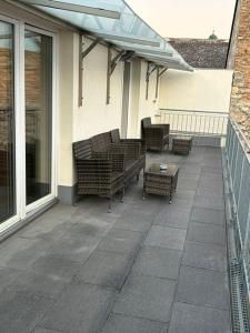 a patio with chairs and a table on a house at Paky Appartements 00323 in Bruck an der Leitha