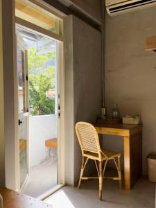 a wicker chair sitting at a desk in a room at DH House in Donghe