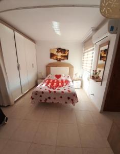 a bedroom with a bed with a red and white blanket at Estudio La Corbeta in Torrox Costa