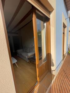 a sliding glass door to a balcony with a couch at Encantador Piso en la Antigua Casa de Correos in Molina de Aragón