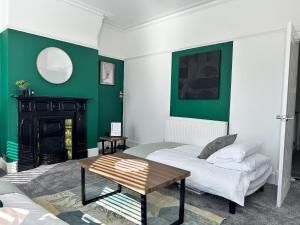 a living room with a couch and a table at 78 Victoria Road in Liverpool