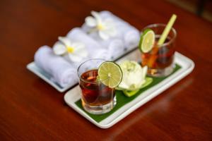 a tray with two glasses of tea on a table at Atoh's Maison in Siem Reap