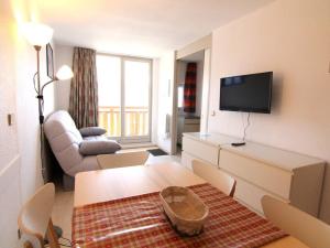 a living room with a couch and a table and a tv at Appartement Huez, 2 pièces, 6 personnes - FR-1-405-40 in L'Alpe-d'Huez
