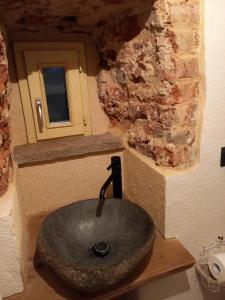 a stone sink in a bathroom with a window at La Boheme in Villanova dʼAsti