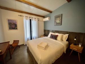 a bedroom with a large white bed and a desk at La Caze Grande Anse in Petite Île