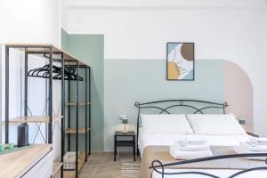 a bedroom with a bed with a black metal frame at Quarzo. Modern Rooms in Cagliari