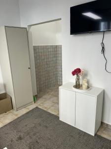 a bathroom with a white cabinet with flowers on it at SleepWell1 in Cologne