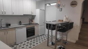 a kitchen with a counter and a sink and a refrigerator at Carmen Alta in Tudela +9 photos