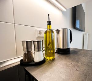 a bottle of oil sitting on a counter in a kitchen at Apartment Düsseldorf City in Düsseldorf