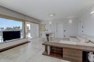 a living room with a couch and a tv at Villa Easy Life by Garda FeWo in Moniga