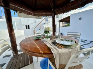 una mesa de madera y sillas en una terraza con mesa y sillón en Casa rural con piscina climatizada en Icod de los Vinos