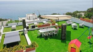 a patio with a table and chairs and the ocean at Villa Nicole Vista Mare in Andrano