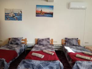 a room with two twin beds and pictures on the wall at Apartman HAX in Sjenica