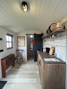 a kitchen with a sink and a counter top at Shepherds Huts in Kidlington