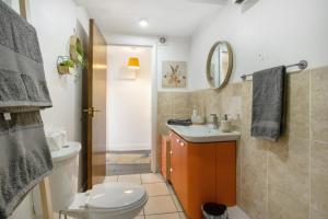 a bathroom with a toilet and a sink and a mirror at Frenchgate Holiday Stay in Richmond