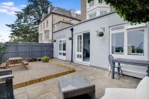 a patio with a table and a bench at Frenchgate Holiday Stay in Richmond
