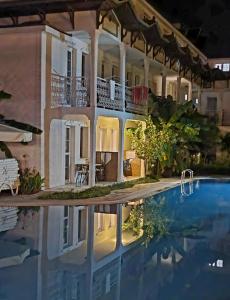 a house with a swimming pool at night at Central Park Otel - Adult Only in Dalyan