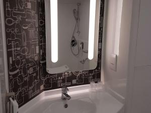 a bathroom with a sink and a mirror at ibis Liverpool Centre Albert Dock – Liverpool One in Liverpool