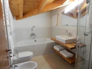 a bathroom with a tub and a sink and a toilet at Villa Primula in Bellagio +79 photos