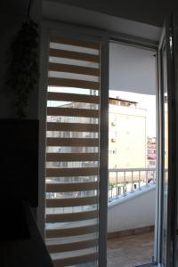 a sliding glass door with a view of a balcony at Cozy Apartment in Skopje in Skopje