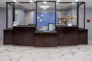a lobby of a store with a reception desk at Days Hotel by Wyndham North Bergen in North Bergen