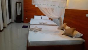Postel nebo postele na pokoji v ubytování White Block Hotel & Resturant