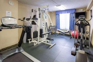 a gym with several tread machines in a room at Days Hotel by Wyndham North Bergen in North Bergen