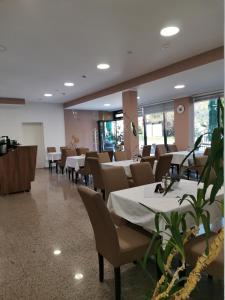 a dining room with tables and chairs in a restaurant at Malena in Goražde