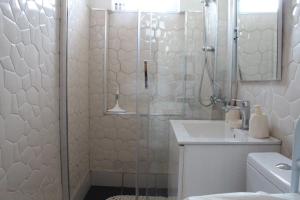 a bathroom with a shower and a sink at Cozy Apartment in Skopje in Skopje +20 photos