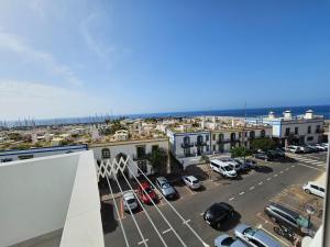 an aerial view of a city with a parking lot at Casa Kevin in Puerto de Mogán