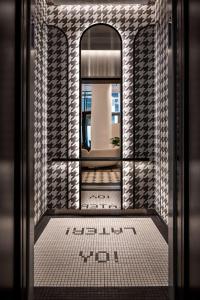 a bathroom with a mirror and a tile floor at Motto By Hilton New York City Times Square in New York