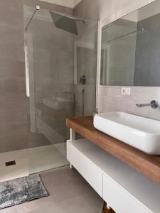 a bathroom with a sink and a glass shower at Il loft in Naples