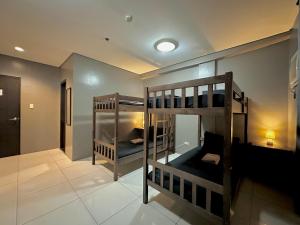two bunk beds in a room with a hallway at Inn De Avenida, Makati in Manila