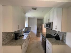 una cucina con armadietti bianchi e forno a microonde di Best location Miami Brickell 3 bedroom Home a Miami