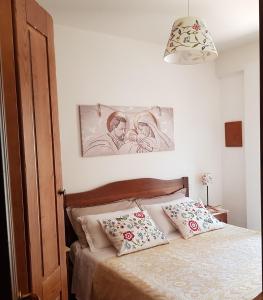 a bedroom with a bed with two pillows on it at Villetta La Pigna in Castel di Sangro