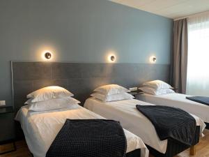 Postel nebo postele na pokoji v ubytování Centrum Hotel Viljandi