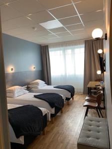 a row of beds in a hotel room at Centrum Hotel Viljandi in Viljandi