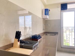 a kitchen with a counter with a sink and a knife block at Juhu Getaway with Rooftop Pad! in Mumbai